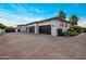 Modern home with a three-car garage, sleek design, and well-maintained landscaping for curb appeal at 9148 N 66Th Pl, Paradise Valley, AZ 85253