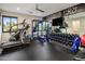Well-equipped home gym with treadmill, weights, and mirrored wall; motivational 'Winners Win' decor at 9148 N 66Th Pl, Paradise Valley, AZ 85253