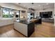 Modern kitchen featuring a large island, sleek white cabinetry, and seamless connection to the living room at 9148 N 66Th Pl, Paradise Valley, AZ 85253