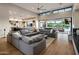 Expansive open-concept living room connected to kitchen with large sectional sofa and sliding glass doors at 9148 N 66Th Pl, Paradise Valley, AZ 85253