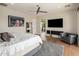 A lovely carpeted main bedroom suite with fan, television, chair, and decorative touches at 9148 N 66Th Pl, Paradise Valley, AZ 85253
