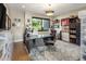 Modern office featuring a gray desk, stylish chairs, wood floors, neutral walls, and ample space with natural light at 9148 N 66Th Pl, Paradise Valley, AZ 85253
