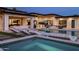 Relax poolside in this luxurious backyard complete with lounge seating and an outdoor kitchen at 9148 N 66Th Pl, Paradise Valley, AZ 85253