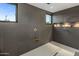 Modern shower featuring beautiful gray tile, rainfall shower head, bench, and recessed lighting at 9148 N 66Th Pl, Paradise Valley, AZ 85253