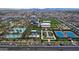 Aerial view of the community featuring pool, clubhouse, park, bocce ball, and tennis courts at 9738 E Tumeric Ave, Mesa, AZ 85212