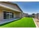 The covered patio leads out to an artificial lawn perfect for entertaining or relaxing at 9738 E Tumeric Ave, Mesa, AZ 85212