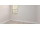 Small, neutral carpeted bedroom featuring a window and white trim at 9738 E Tumeric Ave, Mesa, AZ 85212