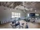 Bright community gym with stationary bikes, wood floors, neutral paint, and exposed ceilings at 9738 E Tumeric Ave, Mesa, AZ 85212