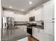 Well-lit kitchen features white cabinetry, stainless steel appliances, and gray countertops at 9738 E Tumeric Ave, Mesa, AZ 85212