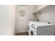 Bright laundry room features a window, shelving, and modern appliances at 9738 E Tumeric Ave, Mesa, AZ 85212