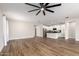 Hardwood living room with white kitchen and stainless steel appliances at 9738 E Tumeric Ave, Mesa, AZ 85212