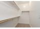 Walk-in closet with carpet floor and built in shelves at 9738 E Tumeric Ave, Mesa, AZ 85212