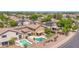 Aerial view of a home with a pool, covered patio, and landscaping in a quiet suburban neighborhood at 981 N Quail Ln, Gilbert, AZ 85233