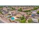 Aerial view showcasing a home with a pool, covered patio, mature landscaping, and desert landscape in a quiet neighborhood at 981 N Quail Ln, Gilbert, AZ 85233