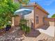 This cozy backyard features an umbrella-covered seating area and desert landscaping at 981 N Quail Ln, Gilbert, AZ 85233