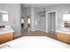 Open bathroom with double sinks, soaking tub, a separate shower, and a large mirror, great for relaxation at 981 N Quail Ln, Gilbert, AZ 85233