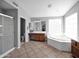 Bright bathroom features a separate shower, bathtub and a wood vanity with ample counter space at 981 N Quail Ln, Gilbert, AZ 85233