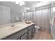 Bright bathroom has a single sink vanity and a shower-tub combo with neutral color palette at 981 N Quail Ln, Gilbert, AZ 85233