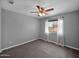 Bedroom boasts neutral carpet and window with white drapes allowing for ample natural light at 981 N Quail Ln, Gilbert, AZ 85233