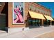 Commercial building featuring yellow awnings, large windows, and striking mural art at 981 N Quail Ln, Gilbert, AZ 85233