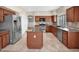 Spacious kitchen featuring stainless steel appliances, granite countertops, and tile flooring at 981 N Quail Ln, Gilbert, AZ 85233