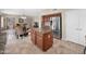 Open-concept kitchen and living area with a large island, stainless steel refrigerator, and tile floors at 981 N Quail Ln, Gilbert, AZ 85233