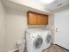 This laundry room has great built-in cabinets over the washer and dryer units at 981 N Quail Ln, Gilbert, AZ 85233