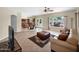 Bright living room featuring tile floors, an open kitchen view, a comfortable couch and outside access at 981 N Quail Ln, Gilbert, AZ 85233