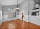 Bright and airy living room with hardwood floors, wainscoting, and large windows with shutters at 981 N Quail Ln, Gilbert, AZ 85233