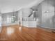 Large living room with vaulted ceiling, wood floors, wainscoting, many windows, and a chandelier at 981 N Quail Ln, Gilbert, AZ 85233