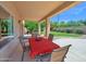 Covered patio dining space overlooking the landscaped backyard, creates an inviting area for outdoor relaxation and entertainment at 981 N Quail Ln, Gilbert, AZ 85233