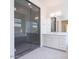 Modern bathroom featuring a glass shower, vanity with a mirror and white cabinets at 10013 S 36Th Ave, Laveen, AZ 85339