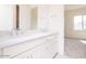 Bathroom featuring dual sinks, quartz countertops and view to the bedroom at 10013 S 36Th Ave, Laveen, AZ 85339