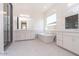 Spa-like bathroom featuring a freestanding tub, dual vanities, and a glass-enclosed shower at 10013 S 36Th Ave, Laveen, AZ 85339