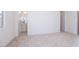 Bedroom view including bathroom entrance, white doors, and neutral carpet flooring at 10013 S 36Th Ave, Laveen, AZ 85339