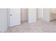 Neutral bedroom with white doors and carpet flooring leads to a bright bathroom at 10013 S 36Th Ave, Laveen, AZ 85339