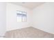 Bright bedroom features neutral carpet and a window letting in natural light at 10013 S 36Th Ave, Laveen, AZ 85339