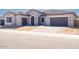 Charming single-story home featuring a tile roof, neutral stucco exterior and a spacious three-car garage at 10013 S 36Th Ave, Laveen, AZ 85339