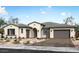 Stunning single-story home showcasing a tile roof, desert landscaping, and an arched entryway at 10013 S 36Th Ave, Laveen, AZ 85339