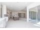 Bright open floor plan with kitchen featuring white cabinets and a dark kitchen island at 10013 S 36Th Ave, Laveen, AZ 85339