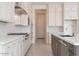 Well-equipped kitchen with white cabinets, stainless appliances, granite countertops and a dark contrasting island at 10013 S 36Th Ave, Laveen, AZ 85339