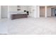 A spacious living room offers great open space, lots of light, and neutral carpeting at 10013 S 36Th Ave, Laveen, AZ 85339