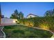 Green backyard featuring lush green grass, privacy hedges, and concrete patio perfect for outdoor enjoyment at 10141 E Floriade Dr, Scottsdale, AZ 85260