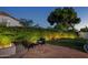 Outdoor patio area featuring flagstone, seating, and lush green hedges, perfect for relaxing and entertaining at 10141 E Floriade Dr, Scottsdale, AZ 85260
