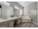 Bathroom with soaking tub, double sinks, and wood-look tile flooring at 10141 E Floriade Dr, Scottsdale, AZ 85260