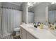 Bathroom featuring an expansive countertop and a shower/tub with a shower curtain at 10141 E Floriade Dr, Scottsdale, AZ 85260