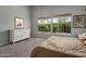 Inviting bedroom featuring dual windows and an ample dresser at 10141 E Floriade Dr, Scottsdale, AZ 85260