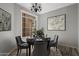 Cozy dining room with hardwood floors, elegant chandelier, and seating for four at 10141 E Floriade Dr, Scottsdale, AZ 85260