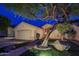Inviting single-Gathering home with a well-manicured lawn, mature trees, and a charming stone walkway at 10141 E Floriade Dr, Scottsdale, AZ 85260