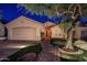 Charming single-story home featuring a stone walkway, two car garage, and mature landscaping at 10141 E Floriade Dr, Scottsdale, AZ 85260